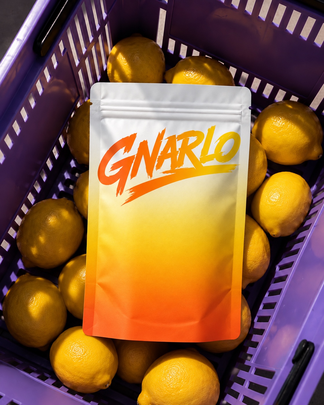 An orange GNARLO pouch in a purple crate of lemons